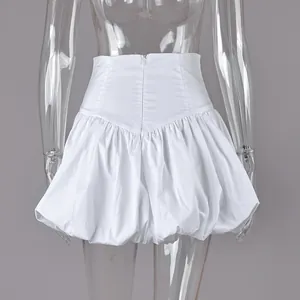Detail showing the back zipper and puffy bubble hem of the white cotton mini skirt.