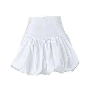 Detail view of a white high-waisted cotton bubble skirt with pleated puff hemline