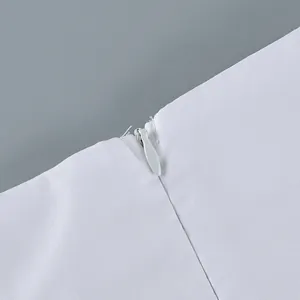 Detailed macro view of invisible zipper on white cotton high-waisted tulip skirt.