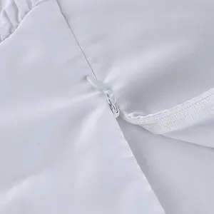 High-quality close-up detail of the concealed back zipper on this white cotton skirt