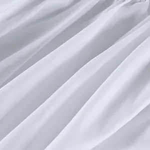 Macro detail of pure white cotton fabric showing fine weave texture for a bubble skirt.