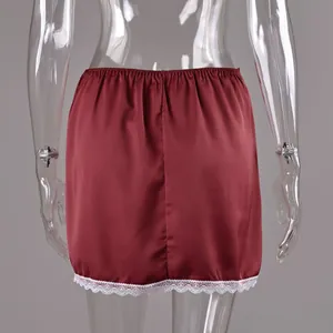 Detail of wine red satin mini skirt with white lace hem shown on a mannequin back view