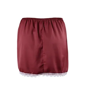 Detailed view of the elegant white lace trim on a burgundy high-waisted satin skirt.
