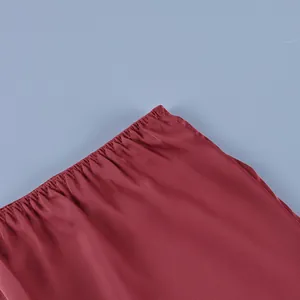 Detailed macro view showing the high waist elastic gathers and red fabric on this skirt