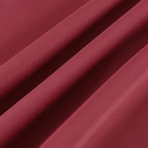 Detailed macro view of the premium burgundy wine red lace fabric texture for high waist skirt