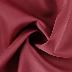 Detailed view of wine red high-quality smooth satin fabric with premium soft luster