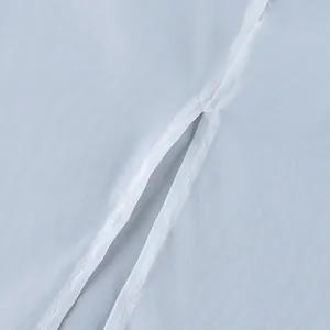 Macro detail view of the high-quality stitching and sheer white piping on a light blue skirt