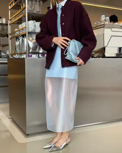 Elegant high-waisted sheer blue midi skirt styled with a burgundy jacket