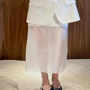 White sheer high-waist midi skirt with a modern and minimalist aesthetic design.