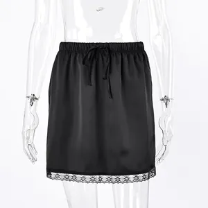 Detailed view of black satin mini skirt featuring drawstring waist and lace trim hem