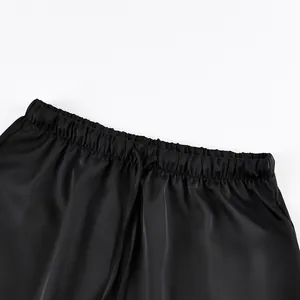 Detailed close-up showing the elastic drawstring waist of this elegant black satin midi skirt.
