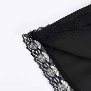 Macro view of the delicate black lace trim on a high-quality smooth satin skirt hemline