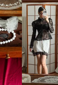Detailed view of white polka dot skirt featuring elegant black lace trim and vintage style