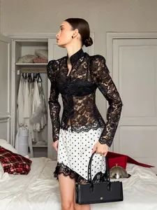 Elegant white polka dot mini skirt with black lace trim for a chic summer look.