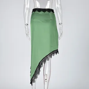 Detailed back view of an asymmetric green satin skirt featuring delicate black lace trim