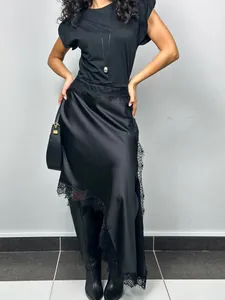 Elegant black asymmetrical satin skirt with delicate lace trim for women's chic style