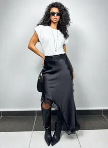High-quality detailed view of asymmetrical satin midi skirt with elegant lace trim details