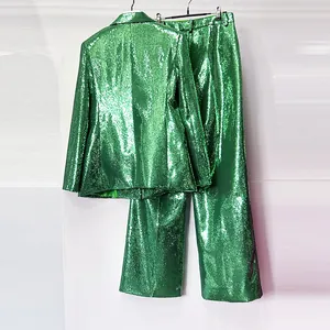 Detail view of a shiny green sequin two-piece suit set with blazer and trousers