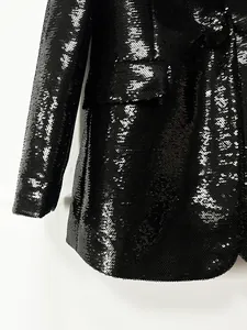 Detailed macro view showing black shining sequins on a stylish women's blazer jacket