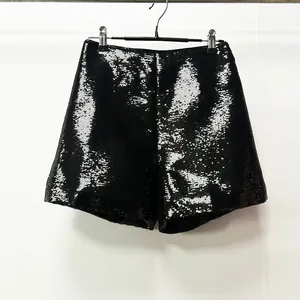 Detailed view of glamorous black sequined shorts featuring a brilliant shimmering finish