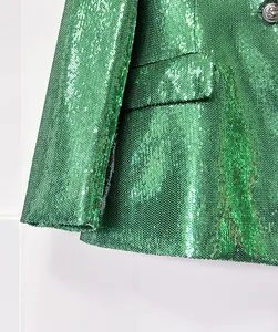 Close-up detail showing the texture of green sequined blazer and silver lion head button
