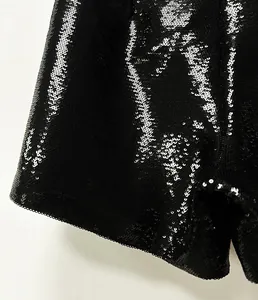 High-detail macro shot of shimmering black sequins on these stylish party shorts