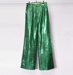 Close-up view of elegant green sequin wide-leg trousers showing shimmering texture
