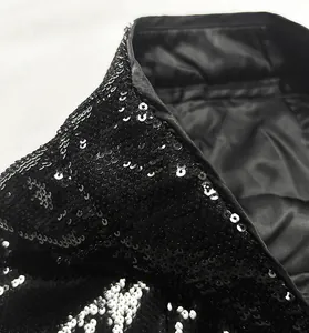 Detailed close-up of a stylish black and white sequin blazer with smooth satin lining