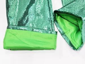 Detailed view of green sequined trousers showing the high-quality lining and shimmer