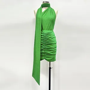 Detailed macro view of the sparkling green rhinestone halter top and ruched skirt set.