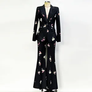 Close-up view of elegant black floral print suit set with blazer and flared pants