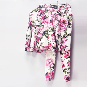 Elegant women's floral blazer and trousers set with vibrant pink peony print patterns