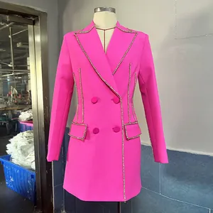 Detail shot of a hot pink double-breasted blazer dress with rhinestone trim on a mannequin