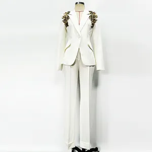 Detailed view of white slim-fit suit set with heavy gold beaded shoulder embellishments