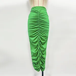 Detailed view of a vibrant green ruched knit skirt with sparkling rhinestones.