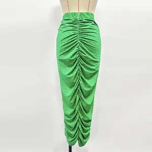 Detailed view of green ruched knitted skirt with sparkling rhinestone embellishments