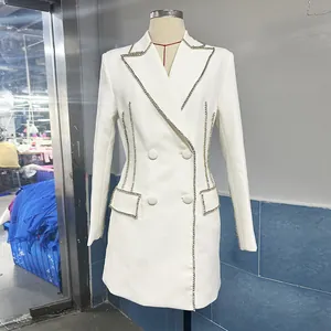 Detailed view of white double-breasted blazer dress with sparkling rhinestone trim
