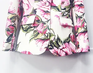 Detail view of floral print blazer with elegant pink flower patterns and pocket flap