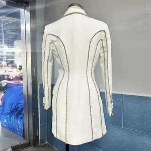 Detailed back view of a white blazer dress featuring elegant rhinestone line embellishments