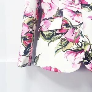 Close-up of elegant pink floral print detail on high-quality white blazer jacket fabric