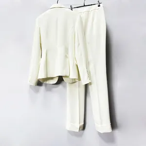 Rear view of elegant off-white slim fit blazer and trousers two-piece suit set