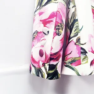 Close-up detail of floral printed blazer sleeve cuff with four fabric covered buttons
