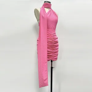 Detail of pink rhinestone halter top and ruched mini skirt set on mannequin