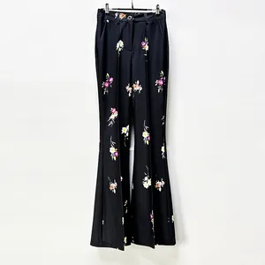 Macro detailed view of elegant black floral printed high-waist flared trousers for women