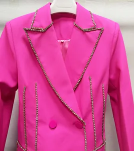Close-up of hot pink blazer dress featuring sparkling rhinestone trim and lapel detail