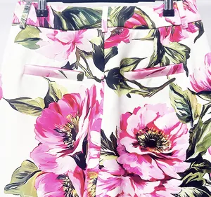 Detailed view of high-waist trousers featuring a vibrant pink peony floral print