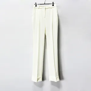 Elegant off-white high-waisted suit trousers with cuffed hems shown on a hanger.