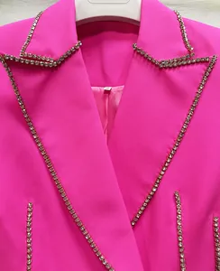 Close-up of pink luxury blazer dress featuring shimmering rhinestone trim detail
