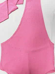 Detailed view of a pink elastic knitted top with sparkling rhinestone patterns on fabric