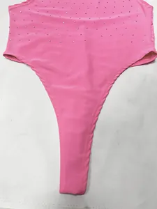 Detail of a pink rhinestone bodysuit top with sparkly gems on elastic fabric